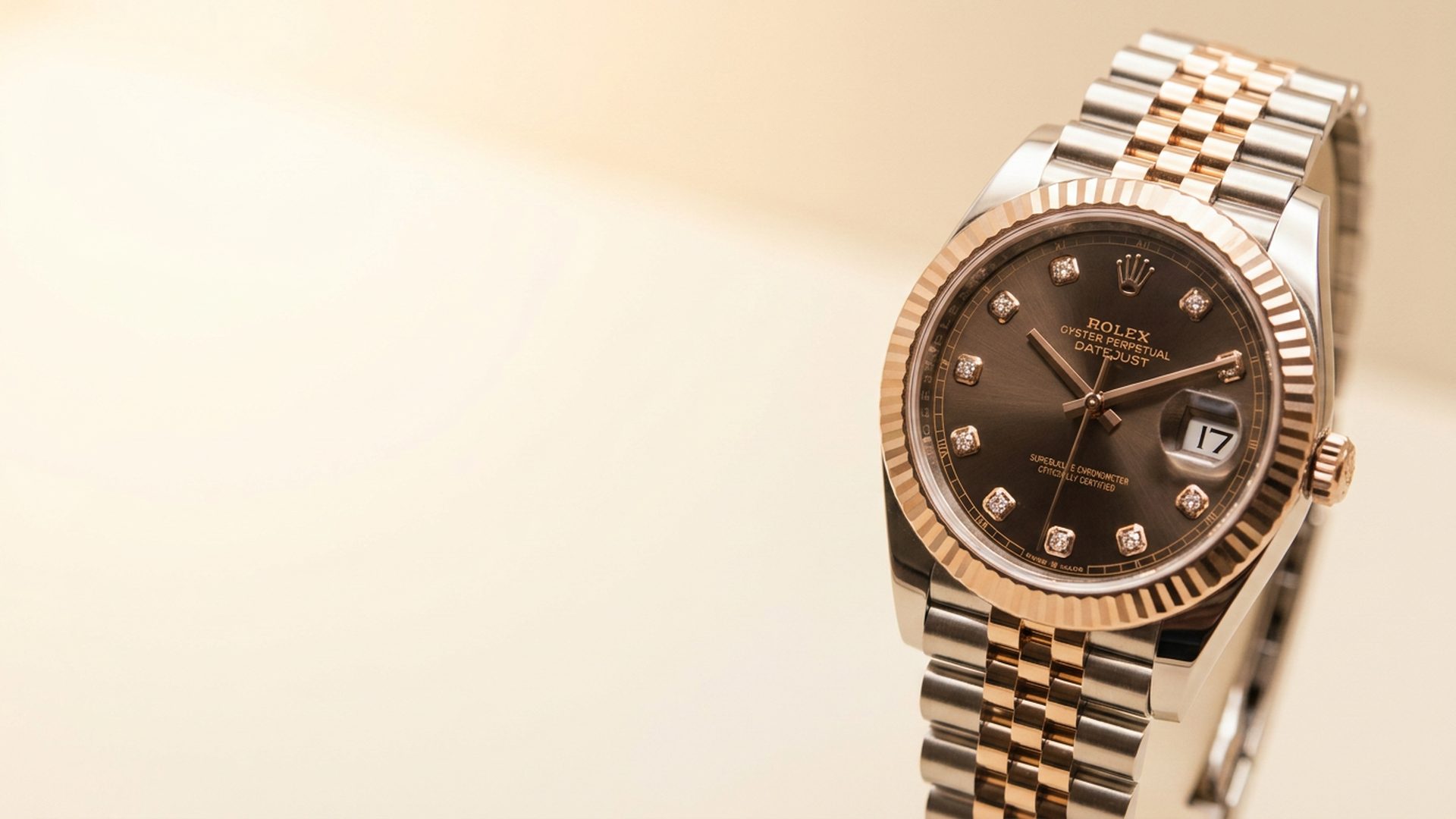 Two-tone Rolex Datejust with diamond dial on a warm ivory backdrop